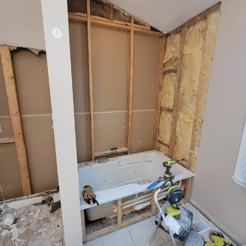 Bathroom renovation rebuild showing new framing and tub installation by Homes by Covenant