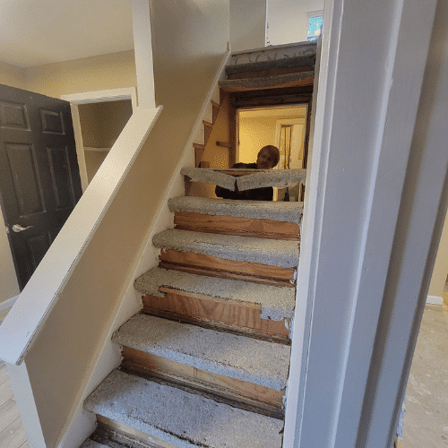 Staircase under renovation showing mid-project progress managed by Homes by Covenant construction team