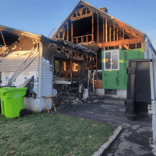 Exterior of fire-damaged home during full structural rebuild managed by Homes by Covenant restoration team
