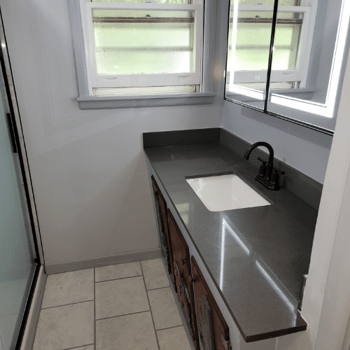 Updated bathroom vanity and countertop installed during complete bathroom remodel by Homes by Covenant in Central New York
