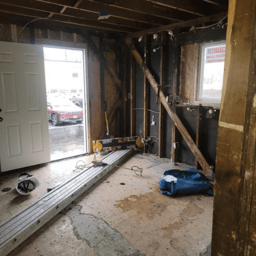 Interior rebuild in progress with exposed framing and wall reconstruction by Homes by Covenant