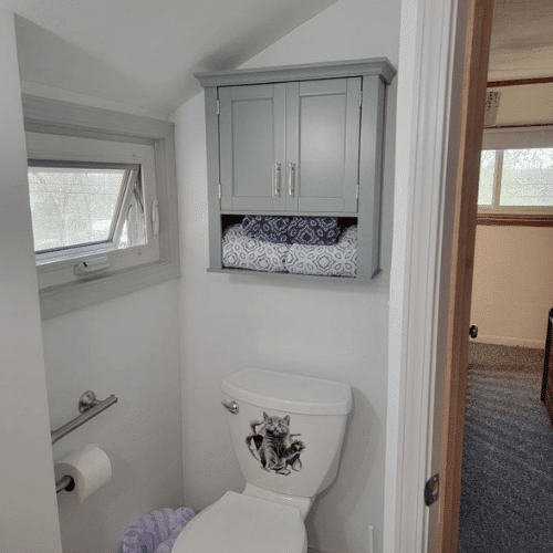 Small bathroom renovation featuring efficient layout and white finishes by Homes by Covenant