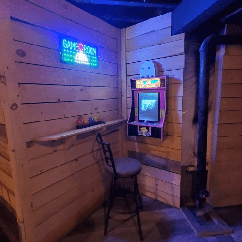 Renovated basement entertainment zone with wood finishes by Homes by Covenant