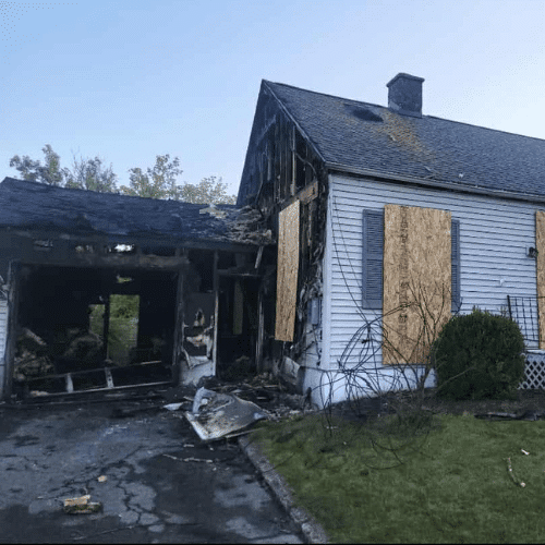 Exterior of fire-damaged home before restoration by Homes by Covenant Fire & Water Restoration team