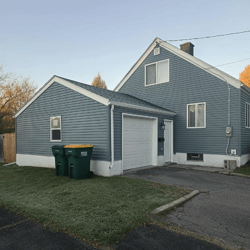 Fully renovated blue-sided home exterior project completed by Homes by Covenant in Central New York