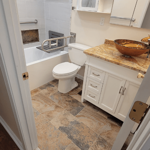 Completed bathroom remodel featuring tile flooring, new vanity, and modern fixtures by Homes by Covenant