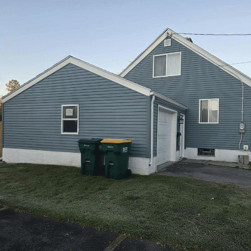 Updated residential exterior with new siding and trim by Homes by Covenant renovation team