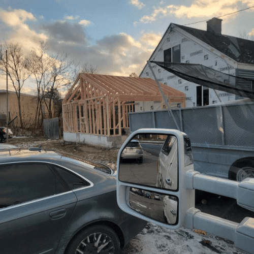 Exterior home renovation nearing completion with siding and trim updates by Homes by Covenant