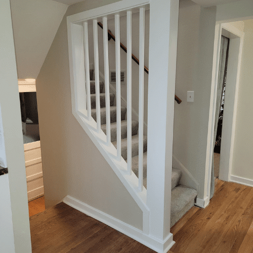 Renovated staircase with new railing and trim installed by Homes by Covenant