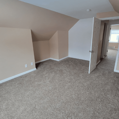 Bedroom renovation completed with fresh paint and modern baseboard heating by Homes by Covenant