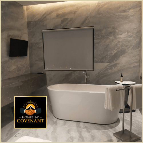Marble bathroom with freestanding tub, stone walls, and modern recessed lighting.