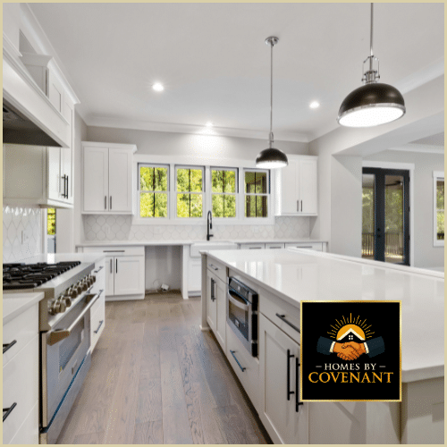 Modern white kitchen renovation with island, stainless appliances, and Covenant craftsmanship.