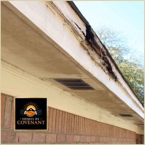 Severely damaged fascia board and deteriorating soffit on a residential home showing rot and weather wear.