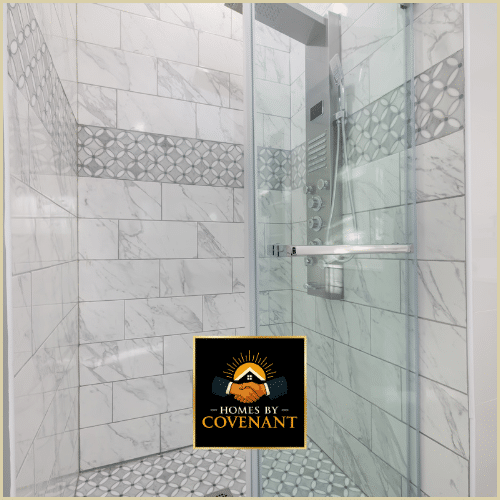 Modern tile shower with marble walls, premium fixtures, and a frameless glass enclosure.