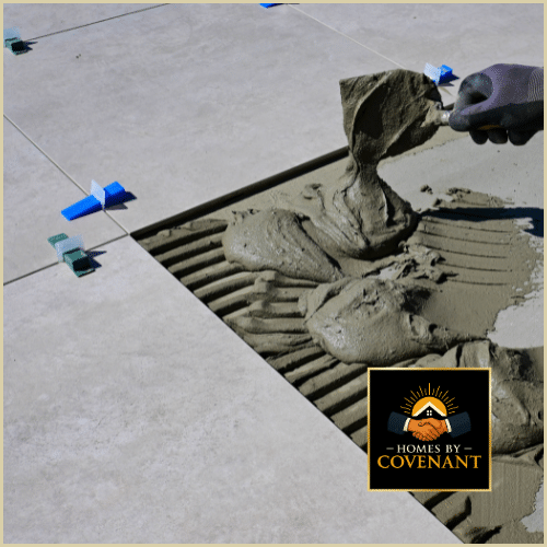Tile flooring mortar being spread for professional tile installation.