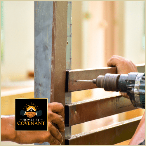 Close-up of technician drilling into exterior railing frame during repair work.