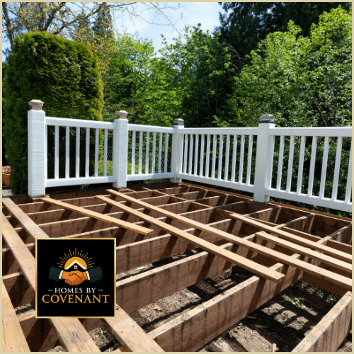 Deck frame under construction showing exposed joists and railing installation area.