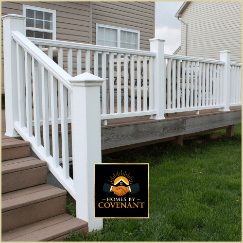 Freshly built white deck railing installed on a raised outdoor platform.
