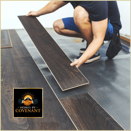 Laminate flooring being installed with clean seams and level alignment.