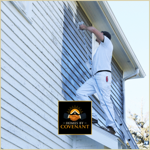 Technician painting residential siding to refresh and protect the home’s exterior.
