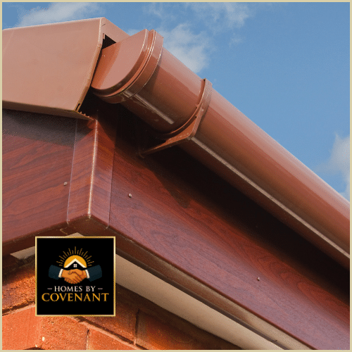 Brown seamless gutter and fascia system installed on a brick home.