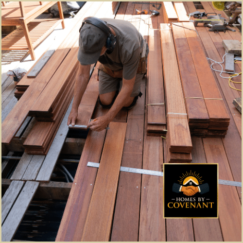 Contractor replacing damaged deck boards during repairs.