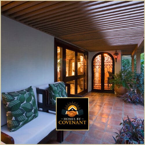 Covered porch with warm wood ceiling, outdoor seating, and welcoming architectural details.