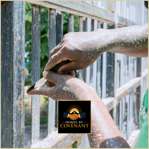 Contractor repairing a wooden fence post with hand tools.