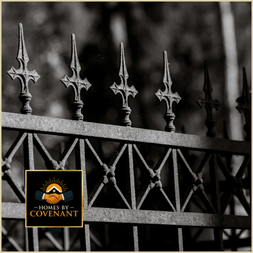 Decorative metal fence with ornamental post caps and accent detailing.
