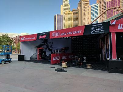 Temporary UFC retail store with branded canopy, merchandise displays, and ticketed entry.