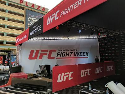 Large-scale UFC Fight Week exterior build with stage, LED panels, and sponsor graphics.