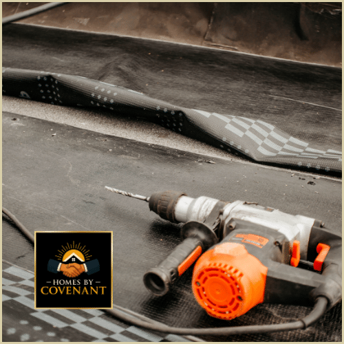 Roofer installing metal drip edge and flashing on a shingle roof