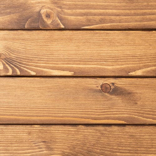 Horizontal natural wood siding with a honey-brown stained finish.