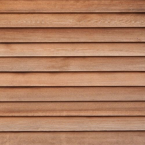 Horizontal cedar-tone wood siding with a natural textured finish.