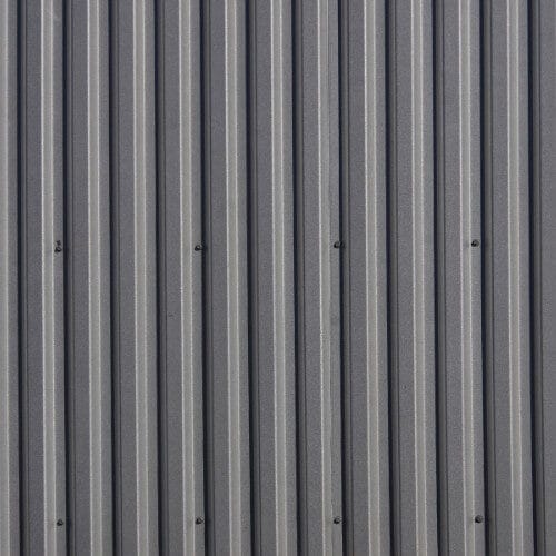 Dark grey vertical corrugated metal siding.